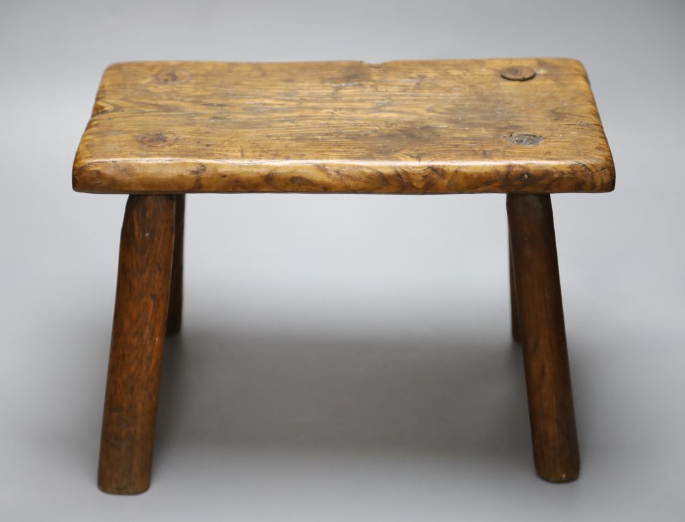 An elm milking stool, length 35.5cm